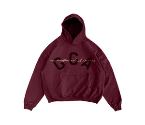 A maroon pullover hoodie with a kangaroo pocket and a graphic on the chest reading 'GCA' in dark letters with the phrase 'no matter what comes' in light script underneath, shown on a plain white background.