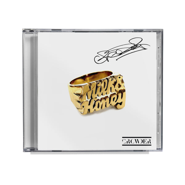 A compact disc case with a clear disc tray, featuring a gold ring with the text 'Milk & Honey' on top, and the artist's name 'CROWDER' at the bottom autographed